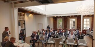 Transformation als Chance sehen: Mittelhessen setzt seine Netzwerke für die Autozuliefer-Branche ein Manfred Wagner (links stehend) begrüßt die Teilnehmerinnen und Teilnehmer aus ganz MIttelhessen beim Runden Tisch für die „Transformationsstrategien für Regionen der Fahrzeug- und Zulieferindustrie“ in den Räumen des Gießener Hotel Heyligenstaedt (Foto: Regionalmanagement Mittelhessen/Manuel Heinrich)