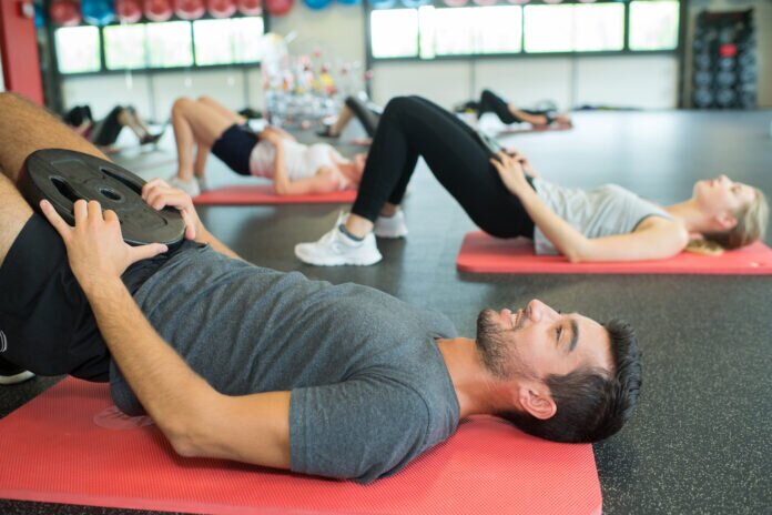 Exercise class doing a pelvic lift